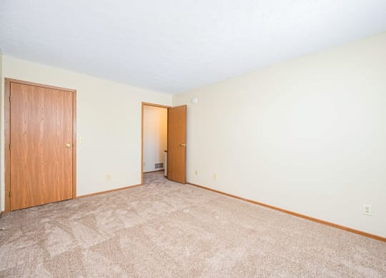 a hallway with white walls and a geometric pattern on the floor