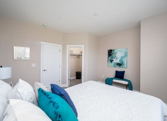 a bedroom with a large bed and a door to a bathroom