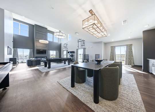 A modern living room with a black table and chairs.