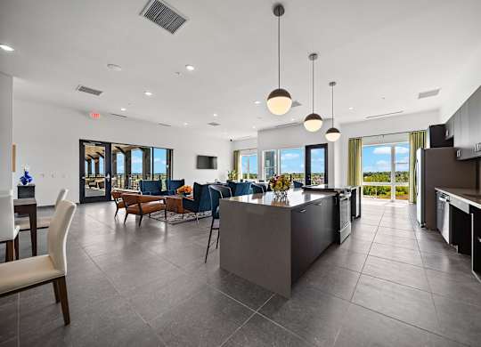 A modern kitchen with a large island and a dining area.