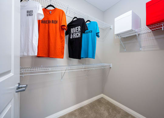 dual closets with towels and tee shirts in a clubhouse