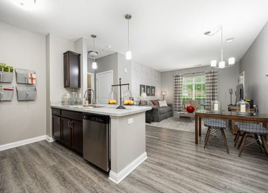 an open kitchen and living room with a table and chairs