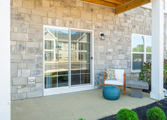 a patio in front of a building with glass doors