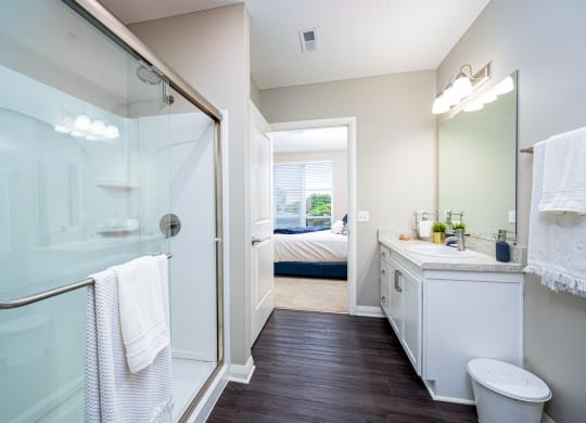 a bathroom with a shower and a sink and a toilet