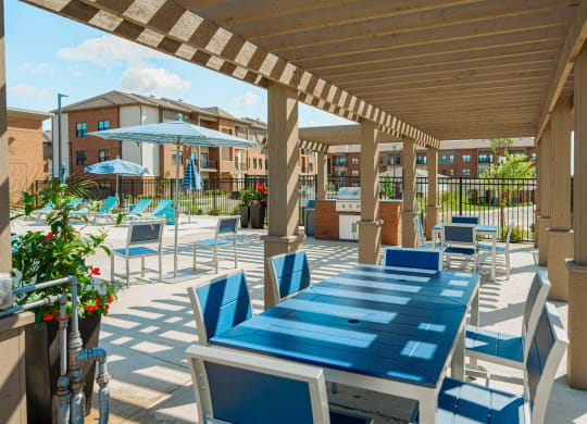 a covered patio with tables and chairs and umbrellas