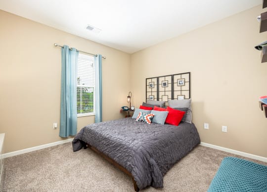 a bedroom with a bed and a window