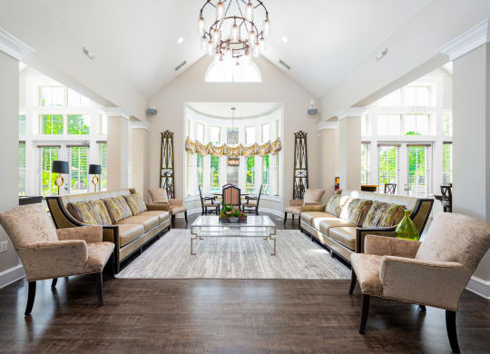 a living room with couches and chairs and a chandelier