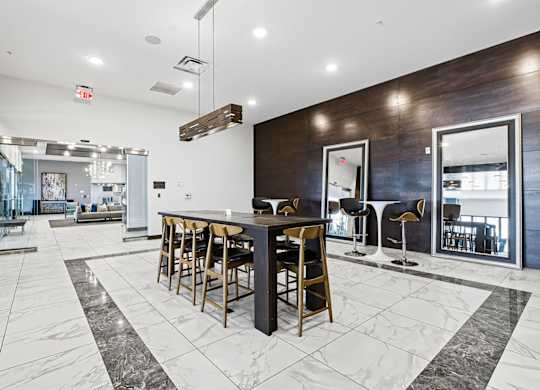 A modern kitchen with a bar area and a dining table.