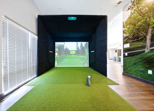 A room with a green carpet and a statue on it.