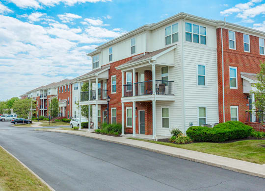an empty street in front of an apartment building