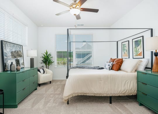 a bedroom with a bed and a ceiling fan