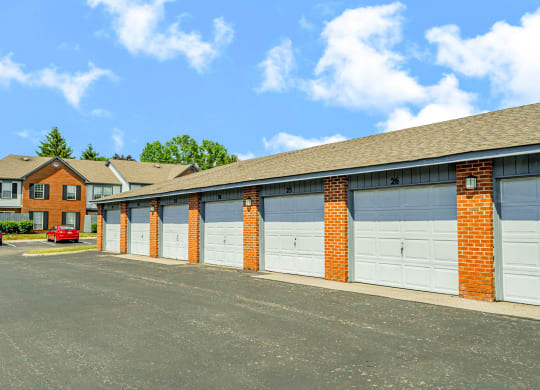 a row of garage doors in front of a house