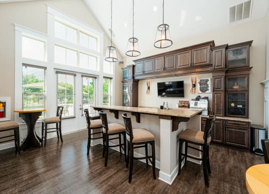 a large kitchen with a large island with chairs
