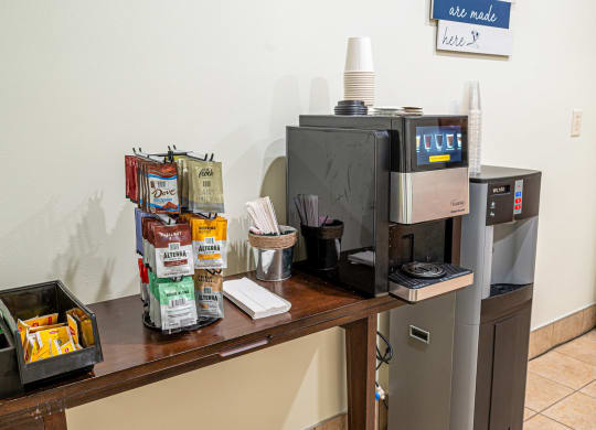a coffee table with a coffee maker and a refrigerator