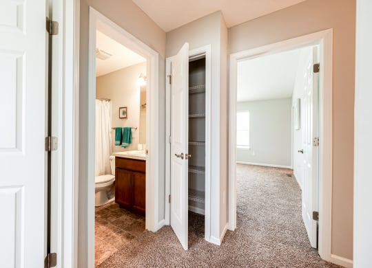 a view of a bathroom with a toilet and a closet