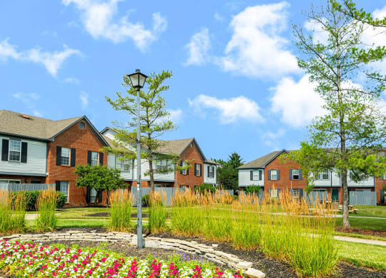 a group of houses with a garden in front of them