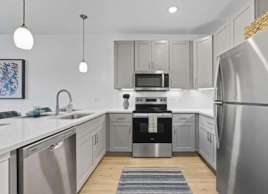 A modern kitchen with a stainless steel refrigerator.