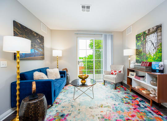 a living room with a blue couch and a window