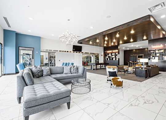A modern living room with a grey sofa and a coffee table.