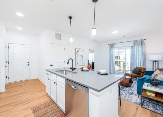 a kitchen with an island and a living room