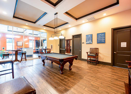 a game room with a pool table and a bar