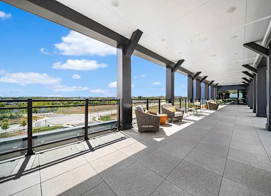 A long covered walkway with a view of the outdoors.