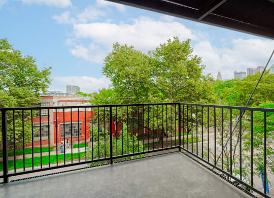 the balcony has a view of the park and the city