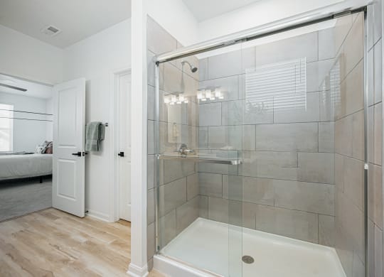 a bathroom with a shower with a glass door