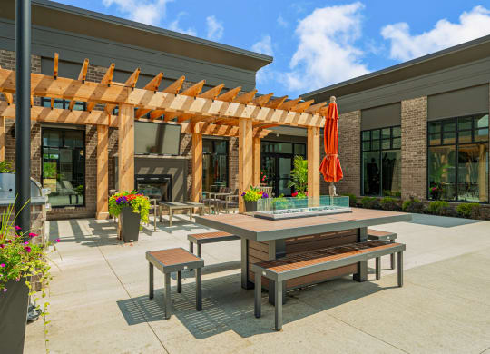 a patio with tables and benches outside of a building
