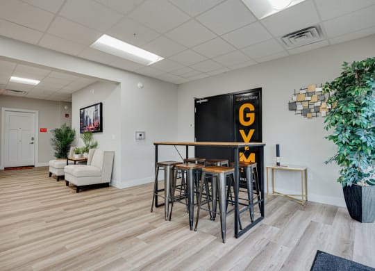 a dining room with a table and chairs and a blackboard with the word go