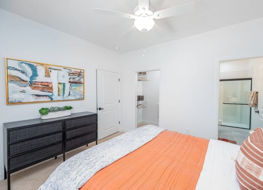 a bedroom with a bed and a ceiling fan