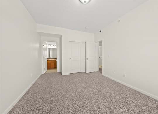 A room with a carpeted floor and white walls.