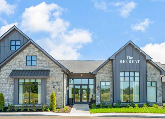 the retreat building with large windows and a blue sky