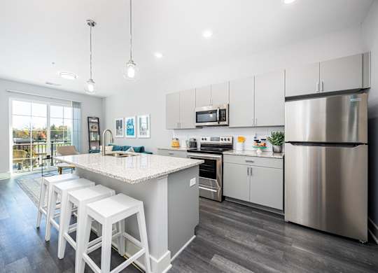 a kitchen with stainless steel appliances and a marble counter top
