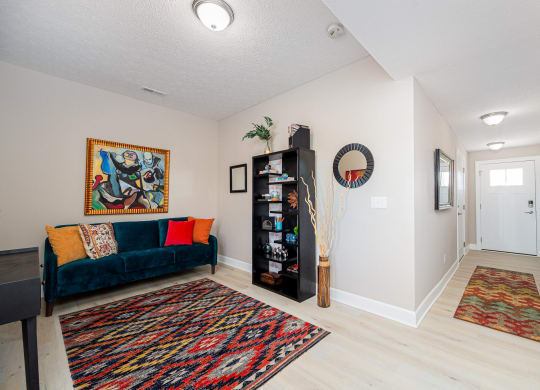 a living room with a couch and a door to a hallway