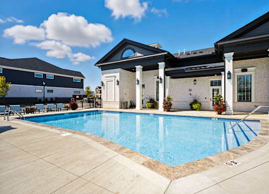 A pool surrounded by a building with columns.