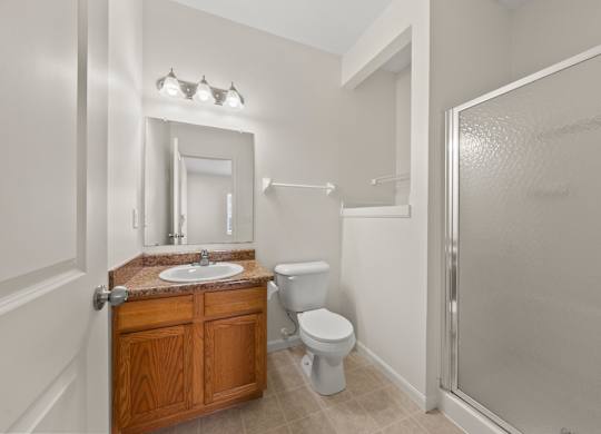 A bathroom with a sink, toilet, and shower.