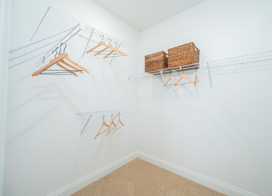 a closet with shelves and baskets on the wall