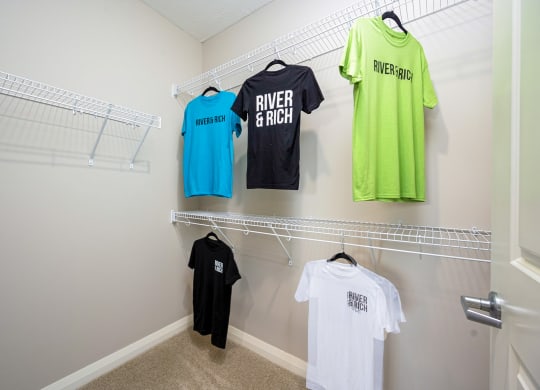 a laundry room with racks of t shirts on the wall