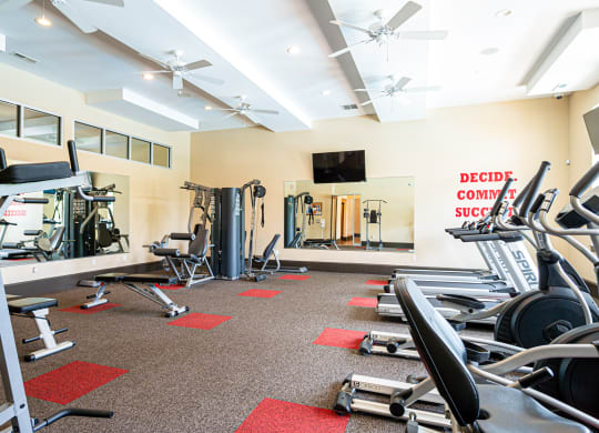 a gym with weights and cardio equipment at the flats