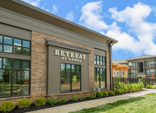 a brick building with a sign that reads retreat at canal