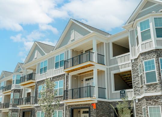 a row of homes with balconies on a sunny day