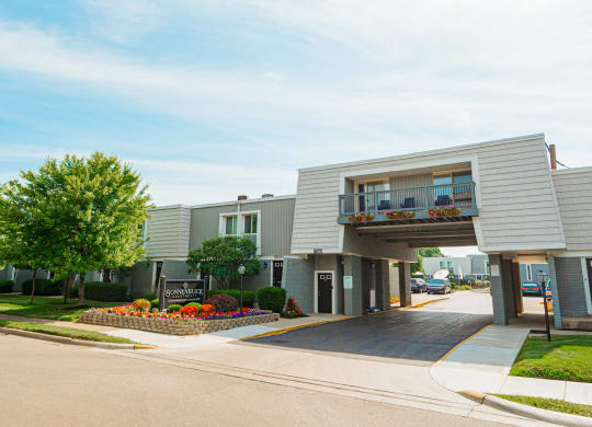 a white building with a balcony and a sidewalk