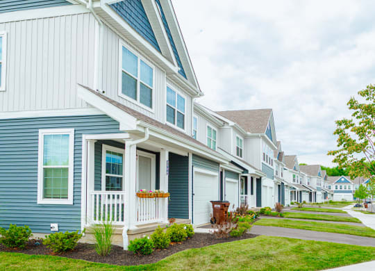 a row of houses with blue and white siding