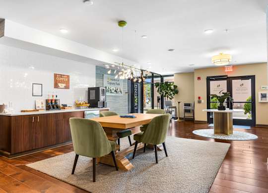 A modern dining room with a wooden table and green chairs.