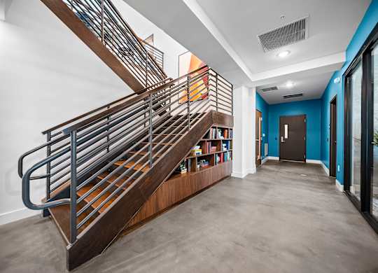 A staircase with a metal railing and wooden steps.
