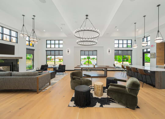 a large living room with couches and chairs and a fireplace