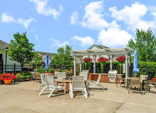 an outdoor patio with tables and chairs and a gazebo