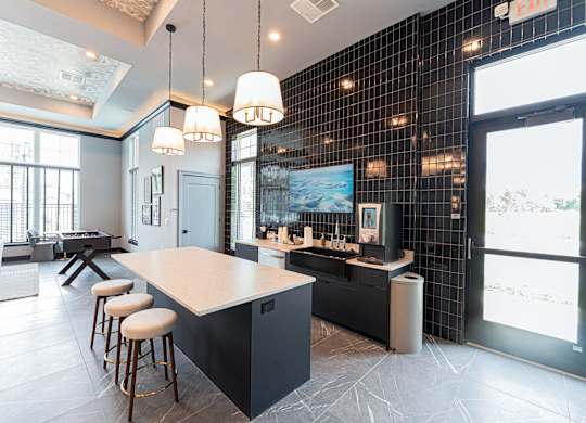 A modern kitchen with a bar area and a dining table.