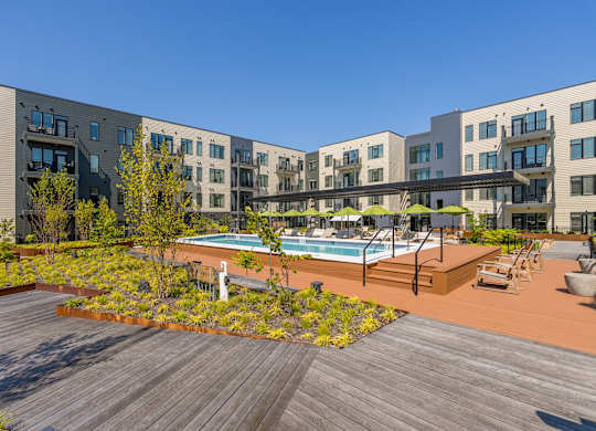 A modern building with a pool in the courtyard.